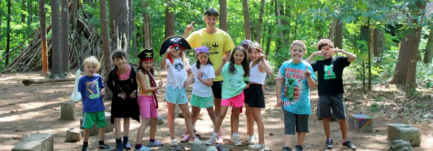 Campers gathered together in the woods at Camp Sargent