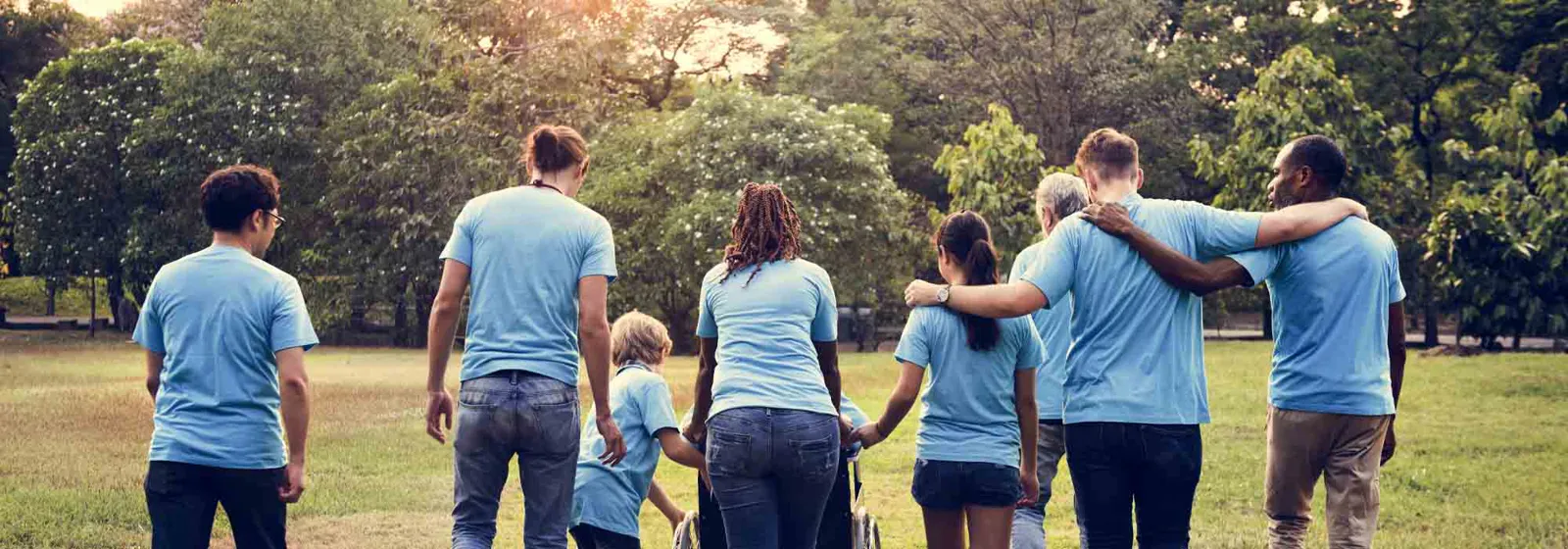 YMCA volunteers in matching shirts walking together in a park