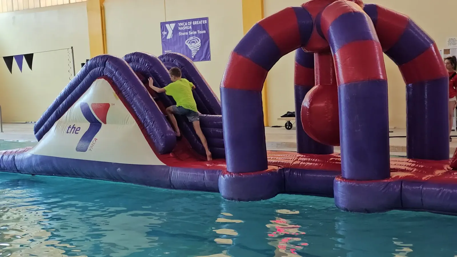 Inflatable obstacle course floating in the YMCA pool